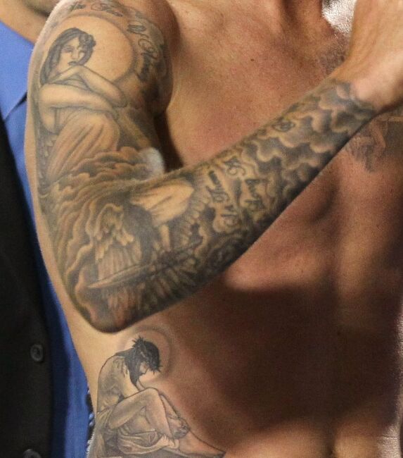 The religious tattoos on his right side