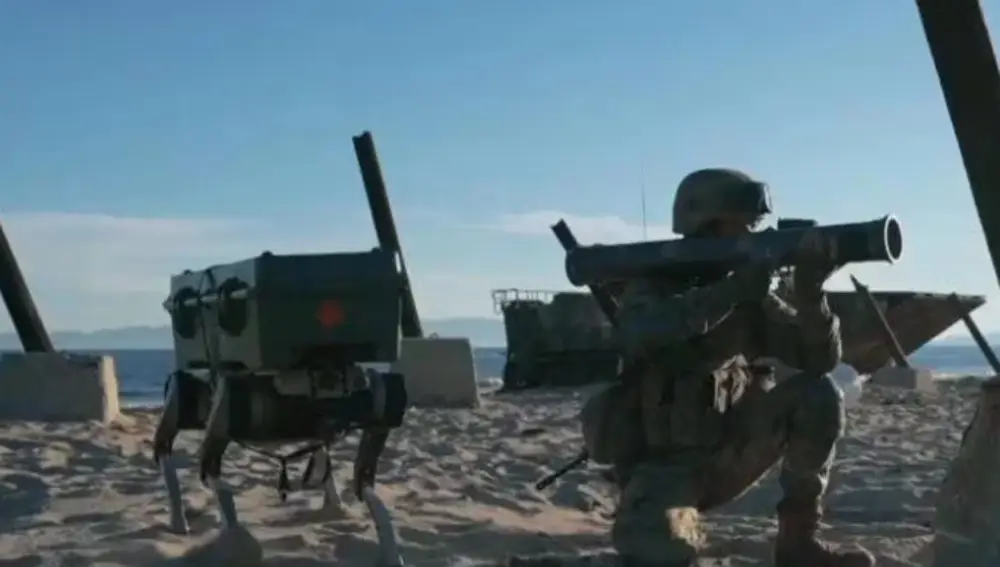 A PLA soldier with one of the robots.