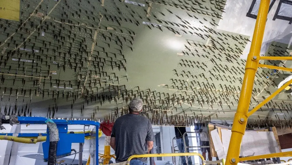 Temporary fixtures were used to trace the hole pattern through four layers of reinforcement. Nearly 35,000 precision holes were drilled into the underside of the plane.